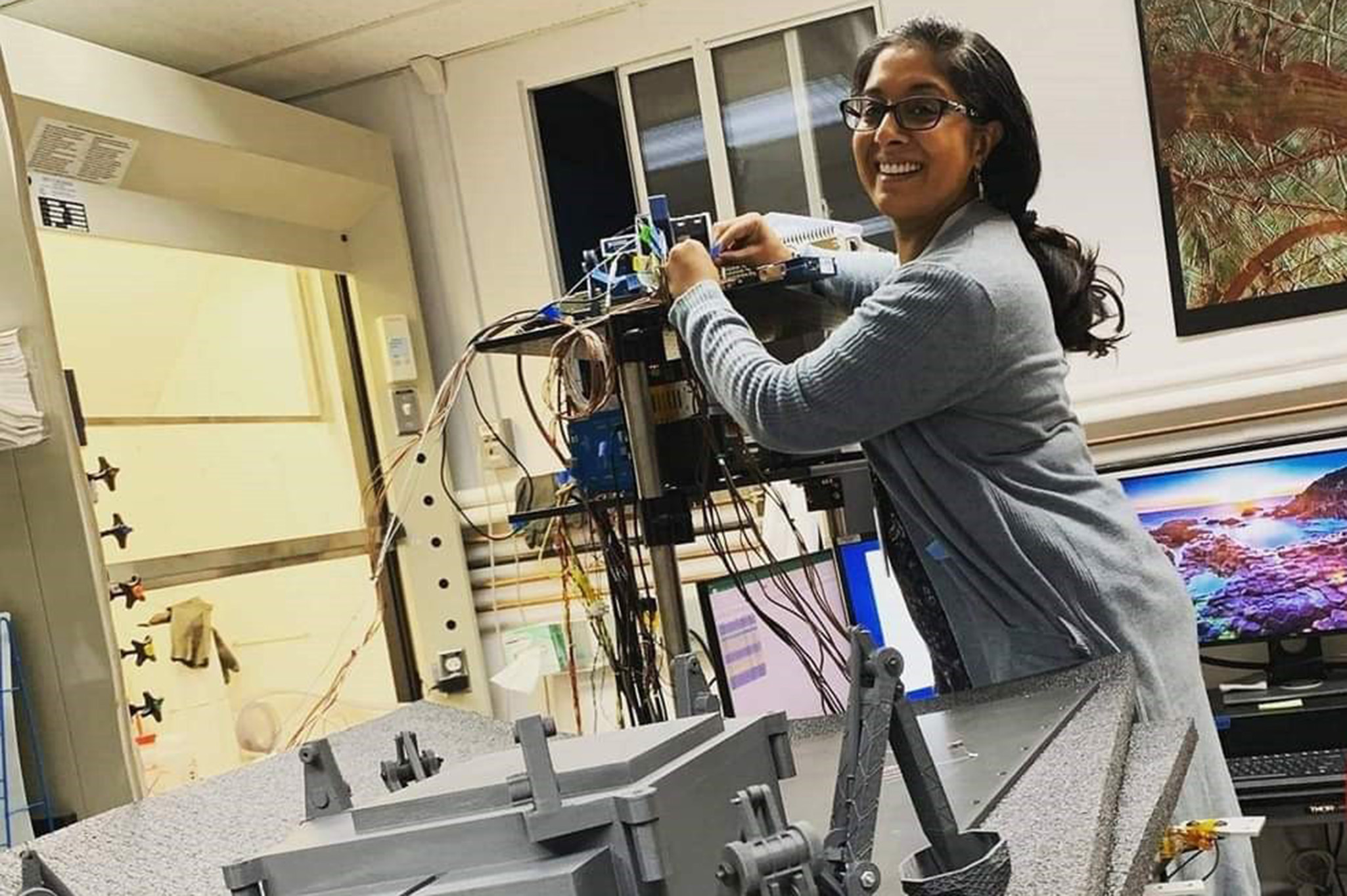 Lavina Backman, a materials engineer in the Spacecraft Engineering Division at NRL, works on setting up the sensor connections for a planetary analog experiment to the Labview module used to collect the data at the Johns Hopkins University Applied Physics Laboratory. (Courtesy photo by Kevin Hand)