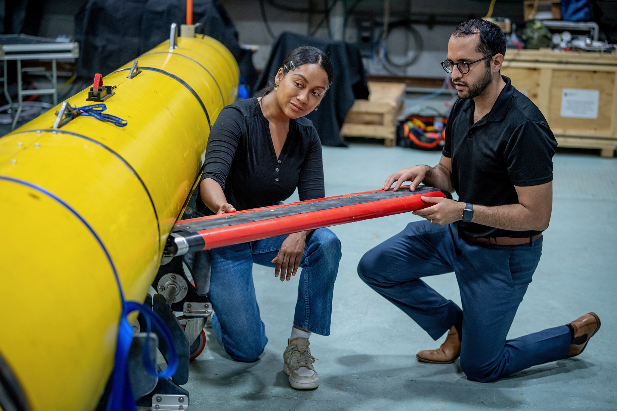 Jade Lopez-Case, a Naval Research Enterprise Internship Program intern and University of Rhode Island graduate student prepares the Skyfish autonomous underwater vehicle (AUV) for at-sea testing with mentor Dr. David Raudales, Active Signatures and Stealth Section, Washington, D.C. (Courtesy photo by Mry F. Calvert)